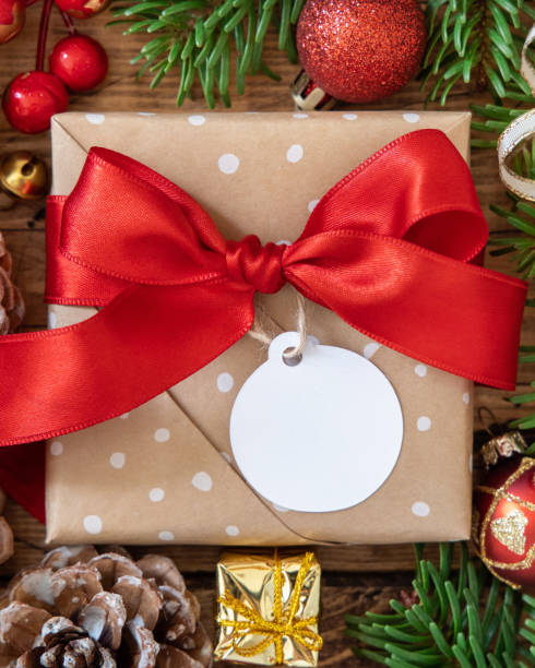 istock Christmas Gift Box with round blank gift tag top view 1346877315