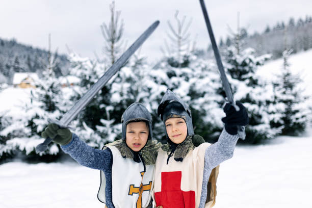 istock Little knights cheering on a winter day 1346879349