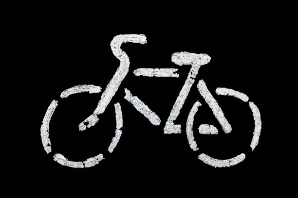 bicycle sign on asphalt with old white paint - isolated on black background.