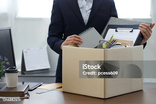 istock Resignation concept.Businesswoman packing personal company belongings when she deciding resignation change of job or fired from the company. 1346882614