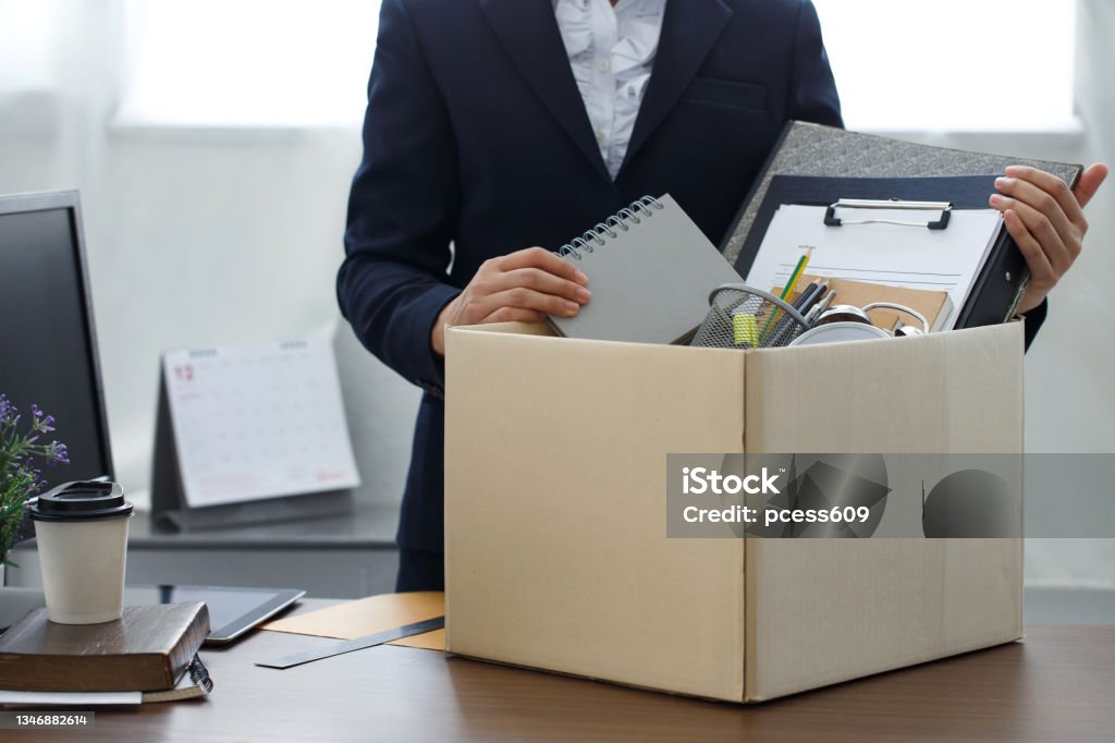 Resignation concept.Businesswoman packing personal company belongings when she deciding resignation change of job or fired from the company. Quitting a Job Stock Photo