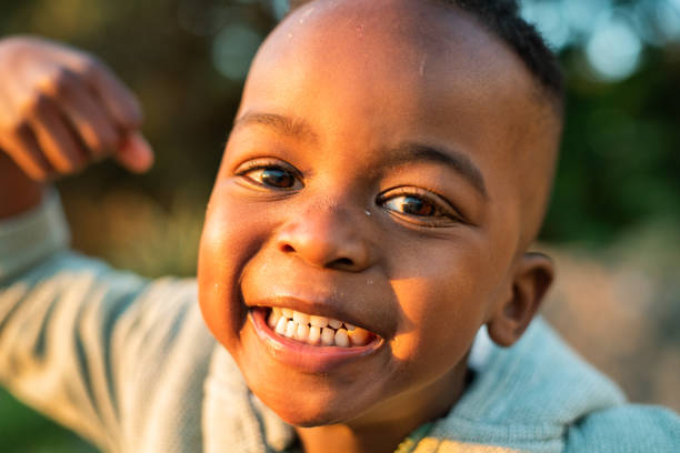 Laughing little boy playing outside on a sunny afternoon stock photo