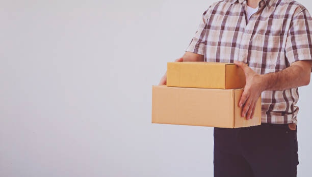 istock Asian young man holding box package, delivery man 1346885816