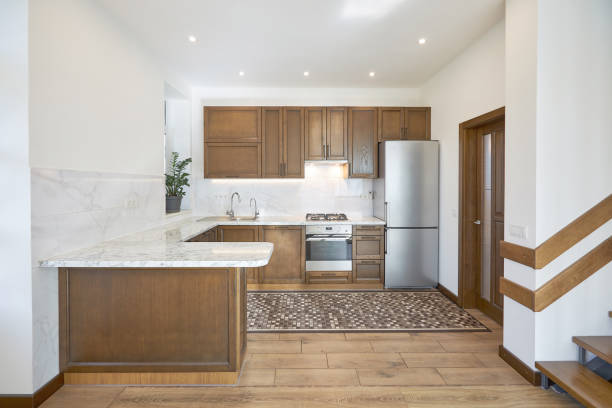 istock Modern wooden kitchen in scandinavian interior with cooking appliances. Real image 1346889404