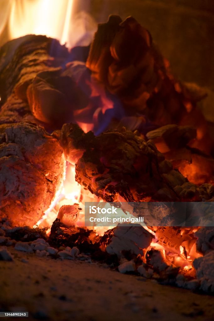 Image of a brick pizza oven with wood and fire Close up of an oven with wood and fire burning inside. Close-up Stock Photo