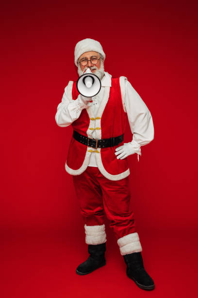 istock Happy, real, funny Santa Claus holding a megaphone 1346890312
