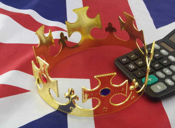 istock Calculator and king crown on British flag. 1346890499
