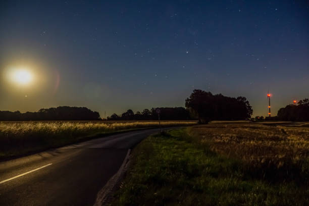 istock A road next to fields in the dark. 1346892545