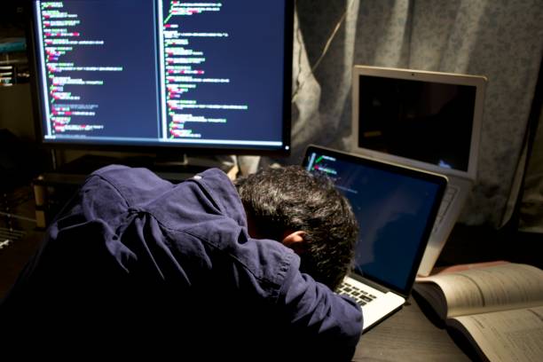 A young Asian programmer starts sleeping during his programming work at his room A young Asian programmer wearing business casual clothes starts sleeping on his desk during programming work at his room cascading style sheets photos stock pictures, royalty-free photos & images