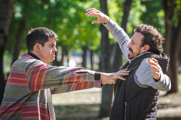 istock Nervous and upset man pushes another during aggressive quarrel conflict 1346894647