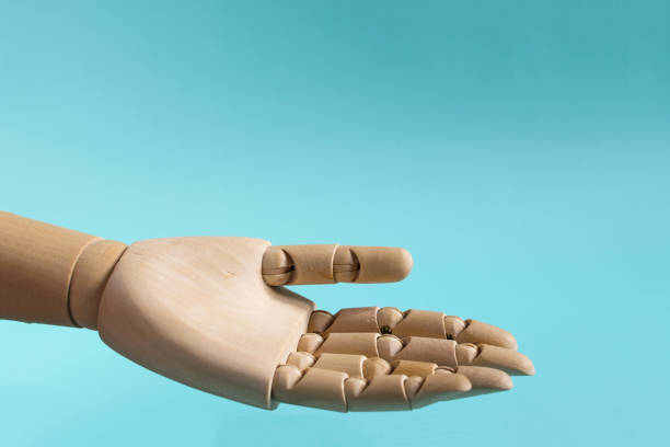 istock A wooden hand with an outstretched finger pointing to an empty place 1346895144