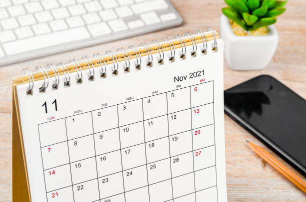 istock november 2021 desk calendar on wooden table. 1346898634