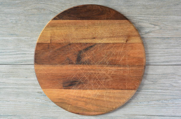 istock Round wooden chopping board, top view 1346898816