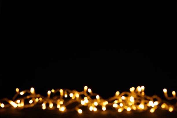 istock Black background with Christmas bokeh lights. Free space for text, copy space. 1346900690