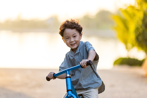 A little boy riding a bicycle