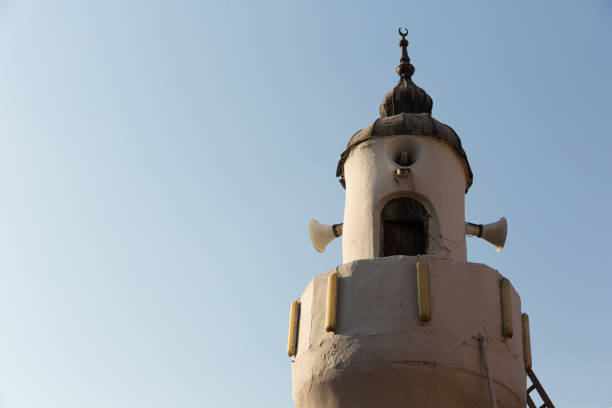 Minaret of an old mosque with alem on top