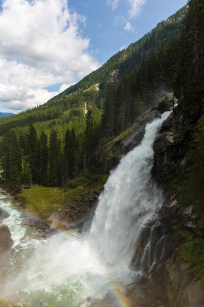 istock Shot of a waterfall with water falling from a high point and creating rainbow, Krimml Waterfalls Austria 1346904780