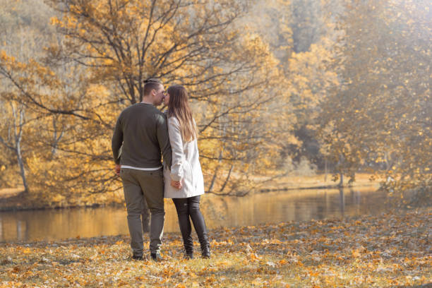istock Young couple walking in the park during autumn 1346907519