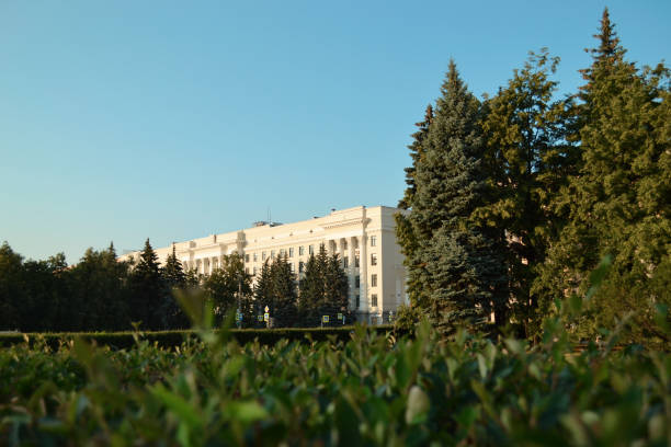 istock Trees and historic building on blue sky background 1346908570