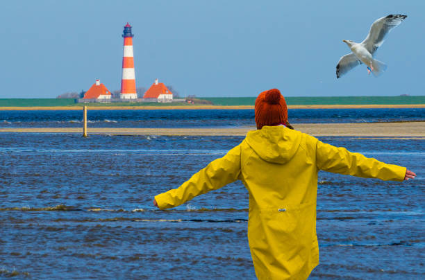 istock Seagull and Woman on Lighthouse Westerhever Germany 1346909058