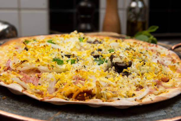 istock Brazilian Portuguese-style pizza with ham, egg, pepper, onion, mozzarella 1346909114