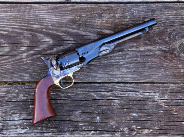 istock Black powder revolver on an old board 1346909800