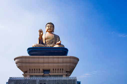 The sitting buddha statue inside of Wihan Phra Mongkhon In Ayutthaya in Thailand.