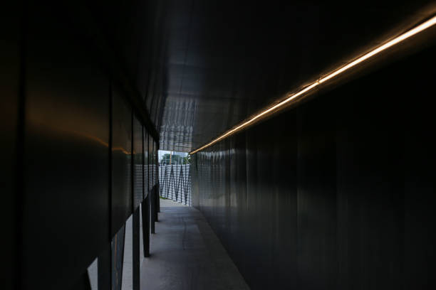 istock Dark pedestrian safety pathway near construction site with small led bulb stripe. 1346910357
