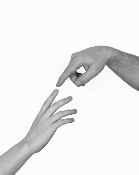 istock Male and female hands touching each other by index finger 1346912653