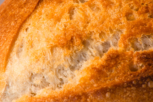 Macro Food: Extreme close-up of tasty crisp bread, warm soft  lighting, horizontal format