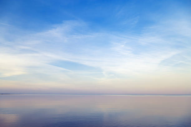 istock Sky background on sunset, colorful clouds. Nature abstract composition with reflections on sea water. Nature environment. 1346916085