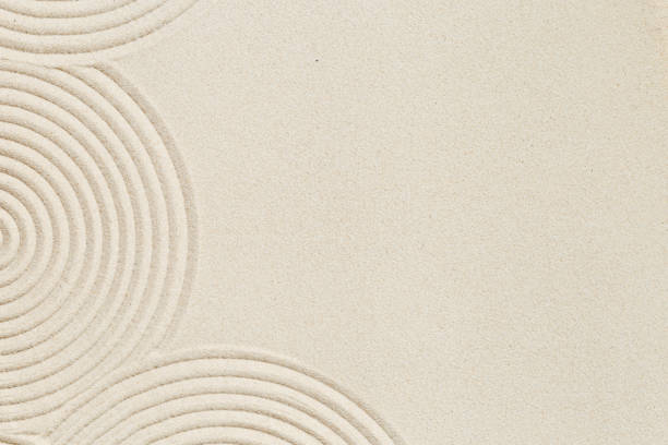 istock Lines drawing on sand, beautiful sandy texture. Spa background, concept for meditation and relaxation 1346916123
