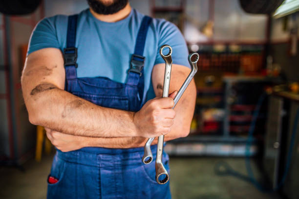 istock Car mechanic with arms crossed 1346917232