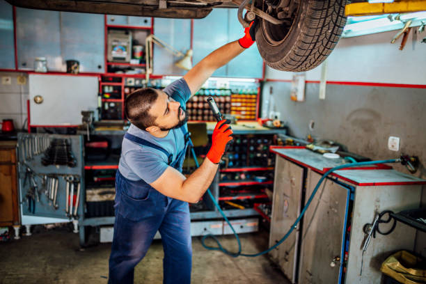 istock Car mechanic inspecting car wheel 1346917467