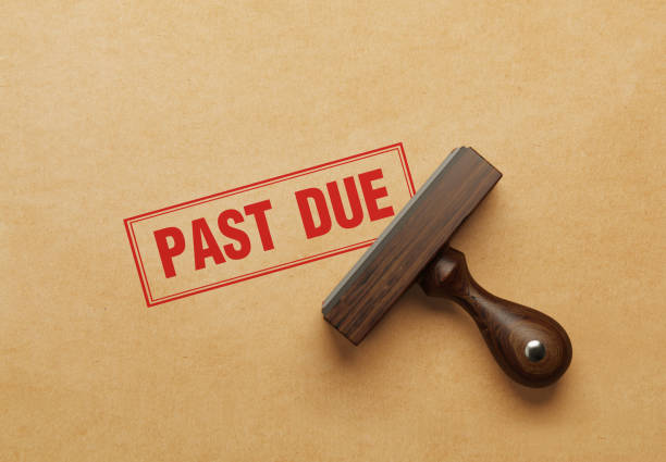 Hands of businessman stamp on paper document to approve business investment contract agreement.