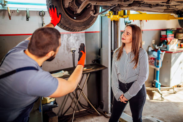 istock Auto mechanic and female customer in garage 1346917939