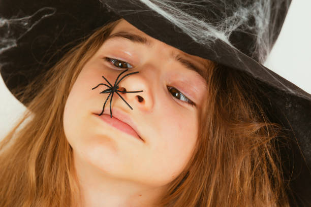 Witch hats and spiders Halloween decoration hanging in sky
