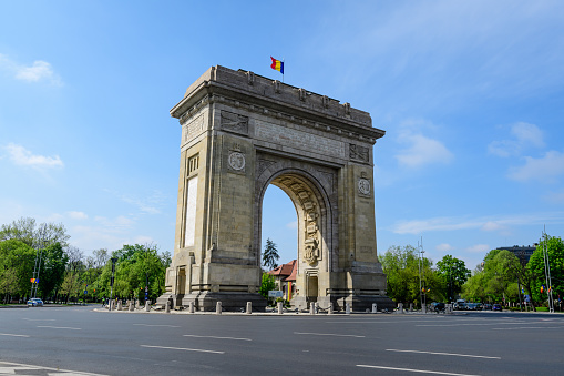 Bucharest, Romania, 30 April 2021: Arcul de Triumf (The Arch Of Triumph) is a triumphal arch and landmark, located in the Northern part of the city on Kiseleff Road near King Michael I (Herastrau) Park