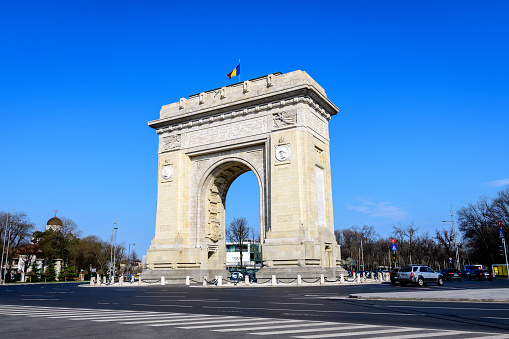 Bucharest, Romania, 3 April 2021: Arcul de Triumf (The Arch Of Triumph) is a triumphal arch and landmark, located in the Northern part of the city on Kiseleff Road near King Michael I (Herastrau) Park