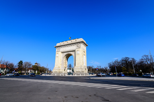 Bucharest, Romania, 3 April 2021: Arcul de Triumf (The Arch Of Triumph) is a triumphal arch and landmark, located in the Northern part of the city on Kiseleff Road near King Michael I (Herastrau) Park