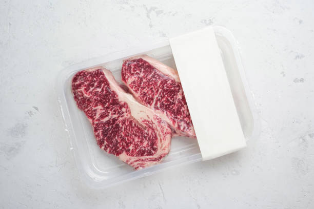istock Raw beef Striploin steak in vacuum packaging, layout for the logo design idea 1346926428