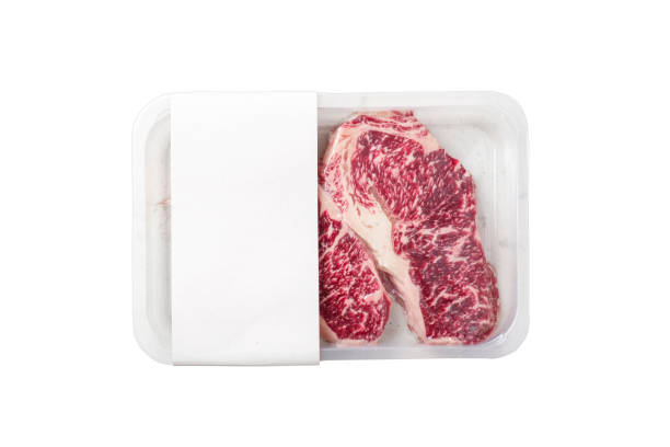 istock Raw Striploin marbled beef steak vacuum Packed isolated on white, logo mockup 1346927018