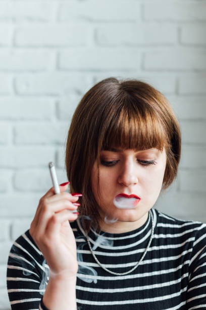 istock Woman Smoking A Cigarette 1346929660