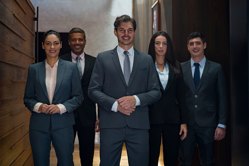 Portrait of a group of successful Latin American business people at the office and looking at the camera smiling - corporate business concepts