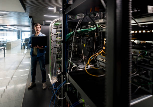 istock Hacker trying to get into a network server at a corporate office 1346929957