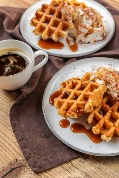 Breakfast Waffles with cream and Caramel syrup with coffee Breakfast Waffles with cream and Caramel syrup with coffee date syrup stock pictures, royalty-free photos & images