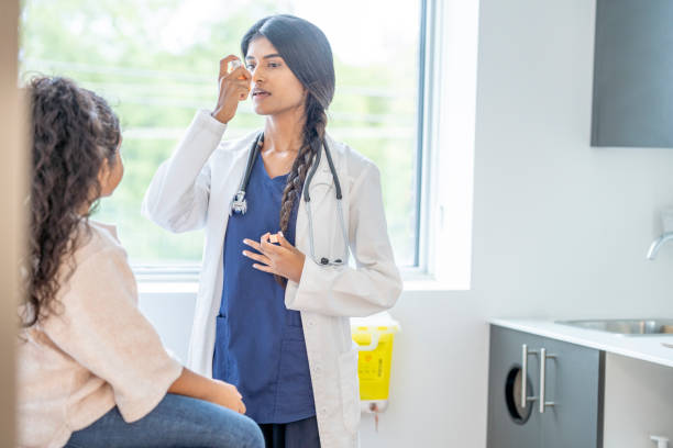 istock Doctor Instructing a Young Patient on Proper Inhaler Usage 1346931640