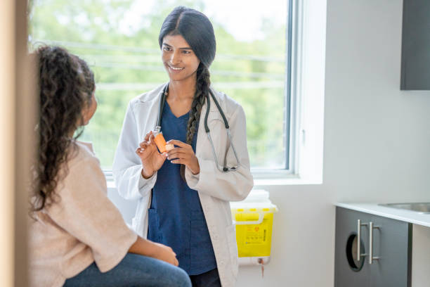 istock Doctor Instructing a Young Patient on Proper Inhaler Usage 1346931642