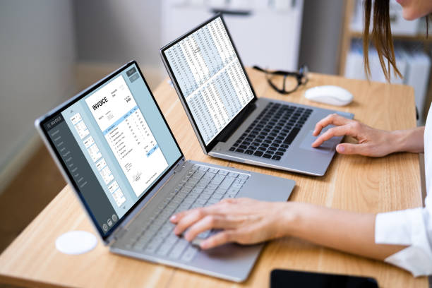 istock Businesswoman Looking At Invoice On Computer Screen 1346931769