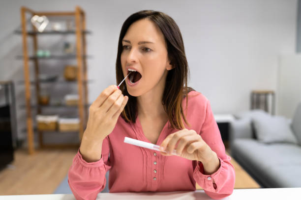 DNA Mouth Saliva Test Swab DNA Mouth Saliva Test Swab. Woman Doing Check cotton swab stock pictures, royalty-free photos & images